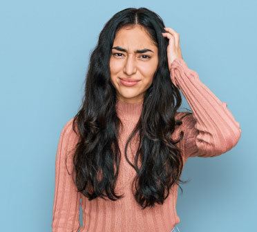 Smiling patient holding orthodontic dentures and retainer